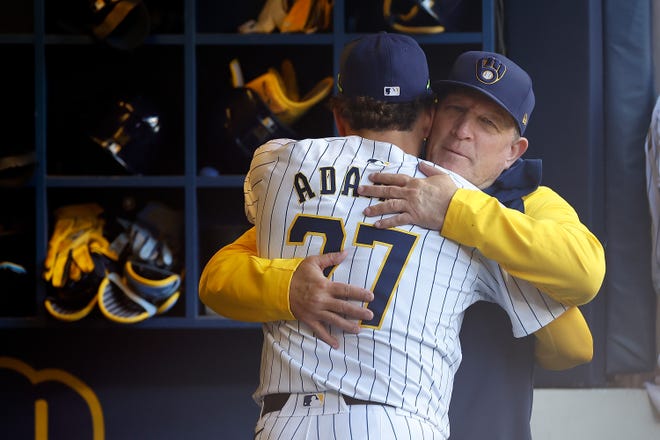 Milwaukee Brewers manager Pat Murphy hugs shortstop Willy Adames.