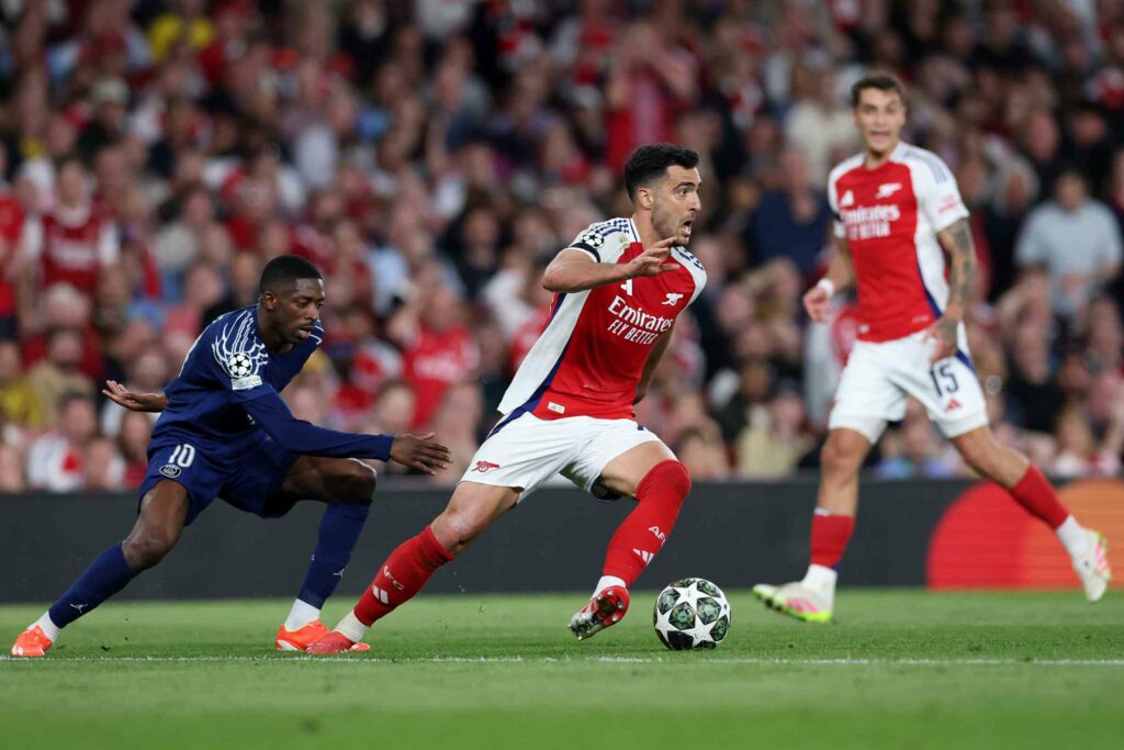 LONDON, ENGLAND - APRIL 29: Mikel Merino of Arsenal runs with the ball whilst under pressure from Ousmane Dembele of Paris Saint-Germain during the UEFA Champions League 2024/25 Semi Final First Leg match between Arsenal FC and Paris Saint-Germain at Emirates Stadium on April 29, 2025 in London, England. (Photo by Michael Steele/Getty Images)