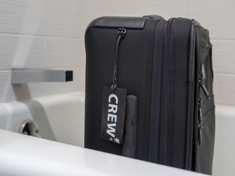 People putting suitcases in Airbnb bathtubs