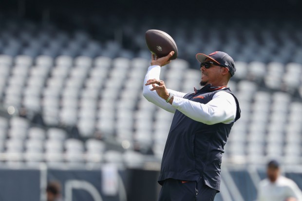 Bears general manager Ryan Poles throws a football on the...