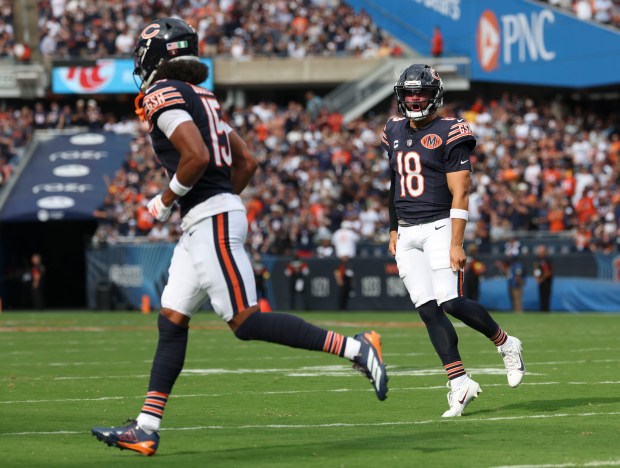 Bears quarterback Caleb Williams celebrates his touchdown pass to wide...