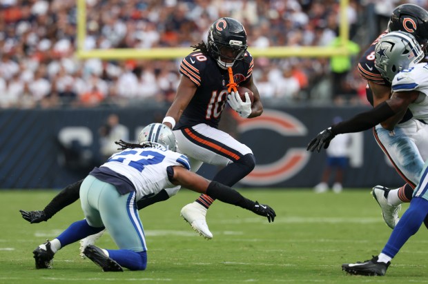 Bears wide receiver Luther Burden III tries to leap Cowboys...