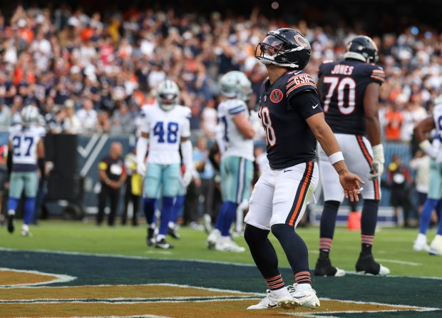 Bears quarterback Caleb Williams celebrates his touchdown pass to DJ...